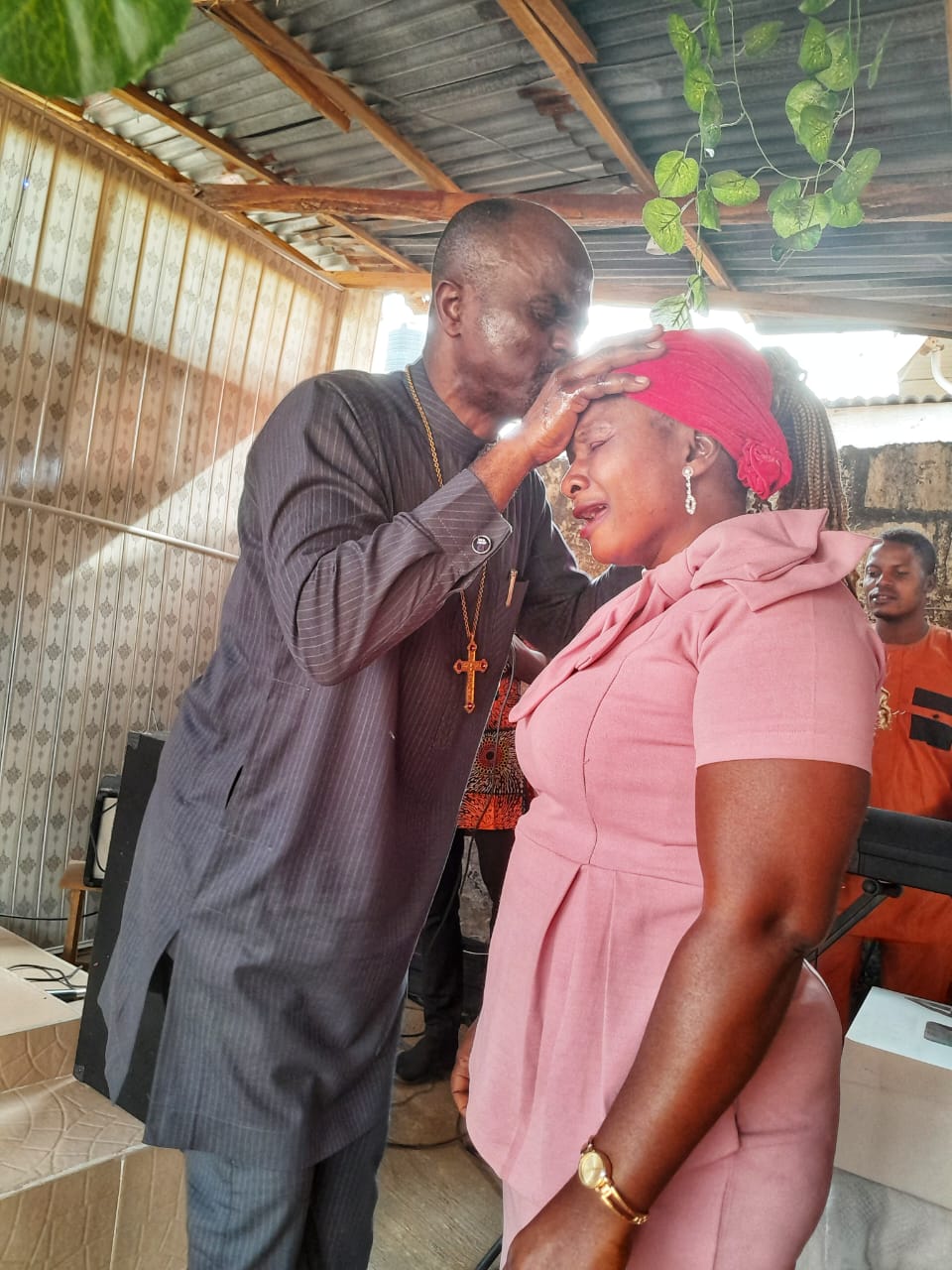 Pastor praying with a church member